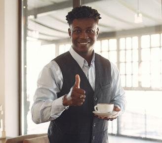 a sharply dressed professional giving a smiling thumbs up