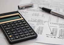 A paper with a budge circled next to a calculator